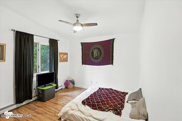 10845 Anvik Cir, Eagle River, AK 99577 - bedroom featuring a baseboard heating unit, lofted ceiling, wood finished floors, and a ceiling fan
