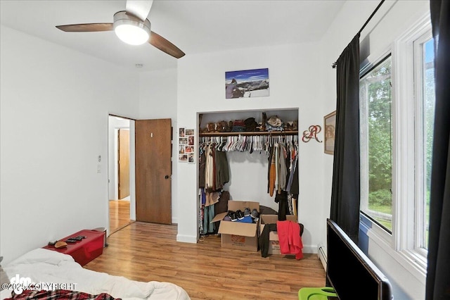 10845 Anvik Cir, Eagle River, AK 99577 - bedroom featuring a closet, multiple windows, wood finished floors, and ceiling fan