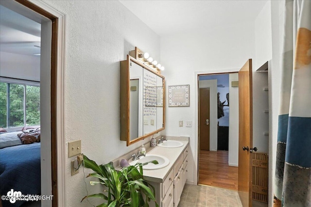 10845 Anvik Cir, Eagle River, AK 99577 - ensuite bathroom featuring double vanity and a textured wall