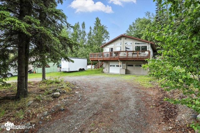 10845 Anvik Cir, Eagle River, AK 99577 - view of front of property featuring driveway, a wooden deck, and a garage