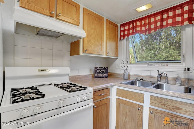 14854 W Fox, Big Lake, AK 99623 - kitchen featuring white gas range, under cabinet range hood, light countertops, and tasteful backsplash