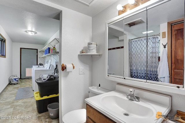 14854 W Fox, Big Lake, AK 99623 - bathroom featuring vanity, separate washer and dryer, a shower with curtain, and stone finish floors