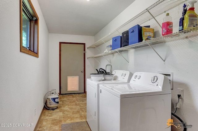 14854 W Fox, Big Lake, AK 99623 - laundry room featuring washing machine and dryer and stone finish floors