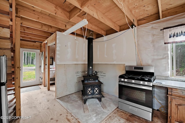 69222 S Parks Hwy, Willow, AK 99688 - kitchen with stainless steel range with gas stovetop, a wood stove, light countertops, and wooden ceiling