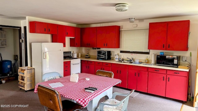 34704 Dolly Way, Sterling, AK 99672 - kitchen with red cabinets, white appliances, light countertops, light colored carpet, and yellow cabinets