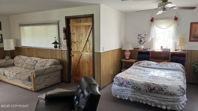 34704 Dolly Way, Sterling, AK 99672 - bedroom featuring a wainscoted wall, carpet flooring, wooden walls, and a ceiling fan