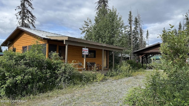 34704 Dolly Way, Sterling, AK 99672 - view of front of property featuring log veneer siding, covered porch, and a metal roof
