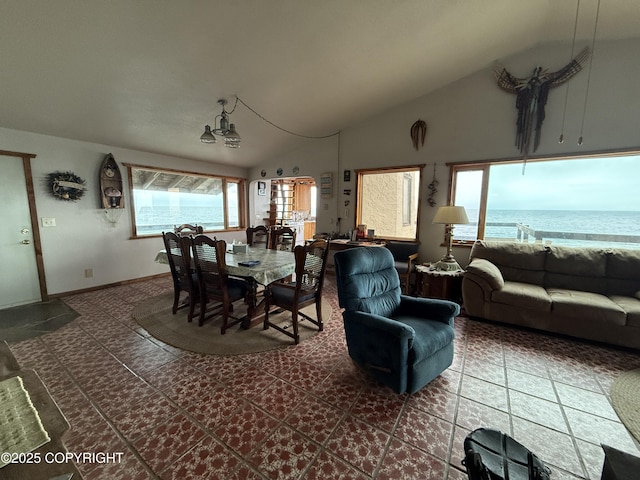 25646 Hawks Beach Rem SW, Anchor Point, AK 99556 - dining area featuring vaulted ceiling, dark tile patterned floors, and a water view