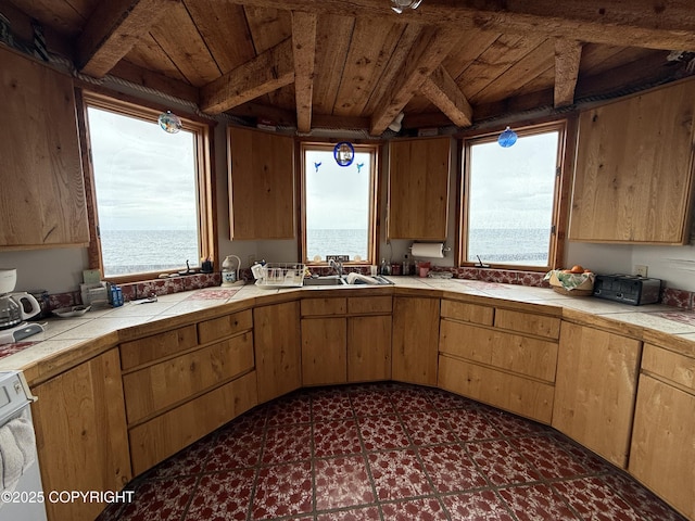25646 Hawks Beach Rem SW, Anchor Point, AK 99556 - kitchen with tile countertops, a wooden ceiling with exposed beams, and range