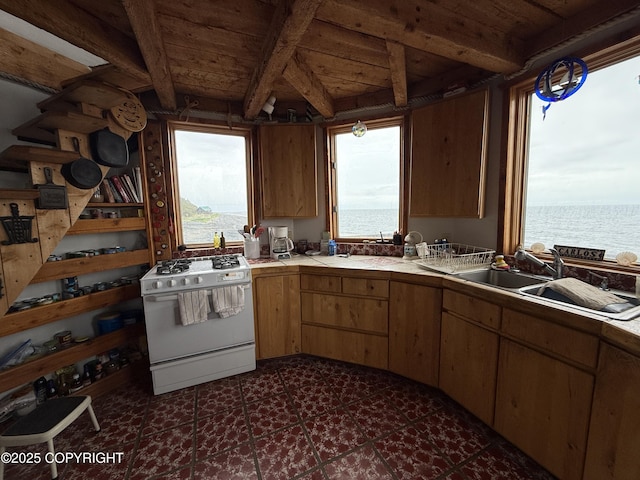 25646 Hawks Beach Rem SW, Anchor Point, AK 99556 - kitchen with white range with gas stovetop, tile counters, plenty of natural light, a water view, and a wood ceiling with exposed beams