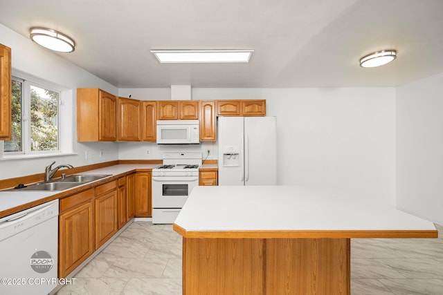 5622 E 4th Ave Unit 12, Anchorage, AK 99504 - kitchen featuring white appliances, light marble finish floors, brown cabinets, light countertops, and a kitchen island