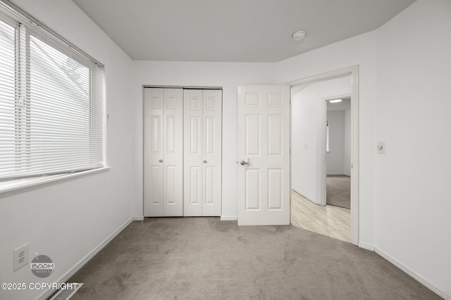 5622 E 4th Ave Unit 12, Anchorage, AK 99504 - unfurnished bedroom featuring carpet floors and a closet