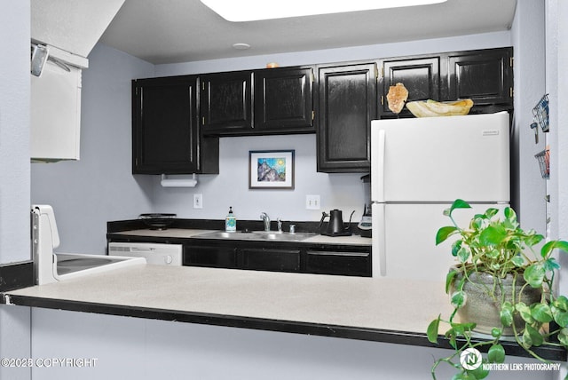 1441 E 17th Ave # 11, Anchorage, AK 99501 - kitchen featuring white appliances and dark cabinetry