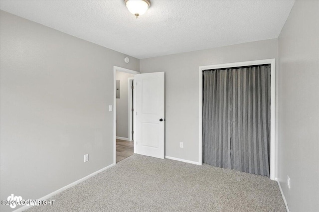 4335 E 6th Ave, Anchorage, AK 99508 - unfurnished bedroom featuring carpet floors, a closet, and a textured ceiling