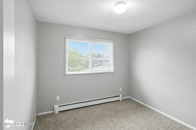 4335 E 6th Ave, Anchorage, AK 99508 - unfurnished room with a baseboard heating unit, carpet, and a textured ceiling