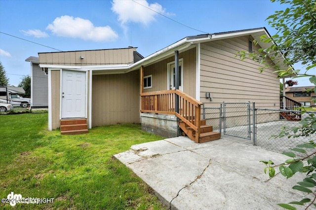 4335 E 6th Ave, Anchorage, AK 99508 - back of property featuring a gate, entry steps, and a patio