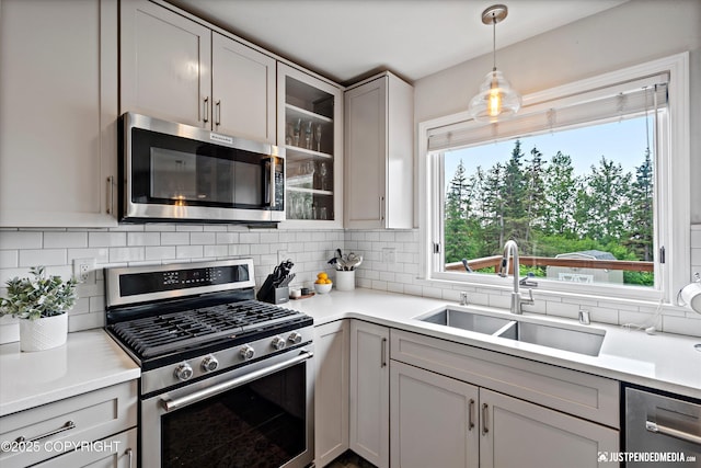 15250 Evergreen Ridge St, Anchorage, AK 99516 - kitchen featuring appliances with stainless steel finishes, decorative backsplash, glass insert cabinets, and light countertops