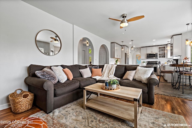 15250 Evergreen Ridge St, Anchorage, AK 99516 - living room with ceiling fan, dark wood-style flooring, arched walkways, and recessed lighting