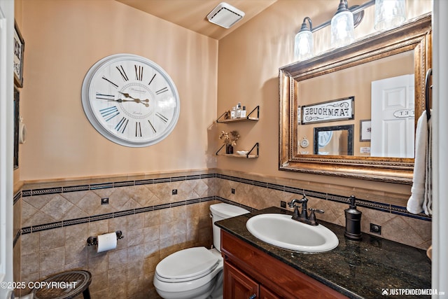 15250 Evergreen Ridge St, Anchorage, AK 99516 - half bath featuring vanity, wainscoting, and tile walls