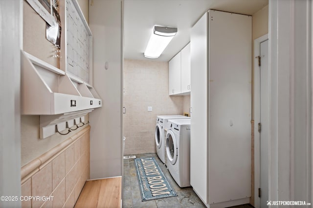15250 Evergreen Ridge St, Anchorage, AK 99516 - laundry area featuring tile walls, independent washer and dryer, and cabinet space