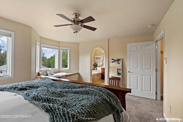 15250 Evergreen Ridge St, Anchorage, AK 99516 - bedroom featuring arched walkways, carpet floors, ceiling fan, and connected bathroom