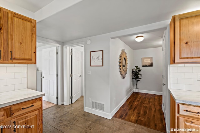 15250 Evergreen Ridge St, Anchorage, AK 99516 - kitchen featuring decorative backsplash and light stone countertops