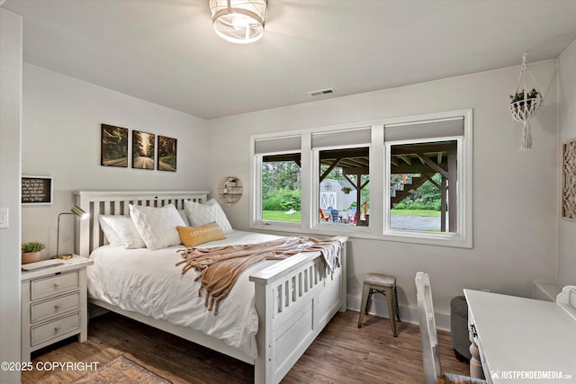 15250 Evergreen Ridge St, Anchorage, AK 99516 - bedroom with multiple windows and dark wood-style flooring