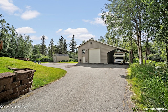 15250 Evergreen Ridge St, Anchorage, AK 99516 - garage featuring a garage, asphalt driveway, and a shed