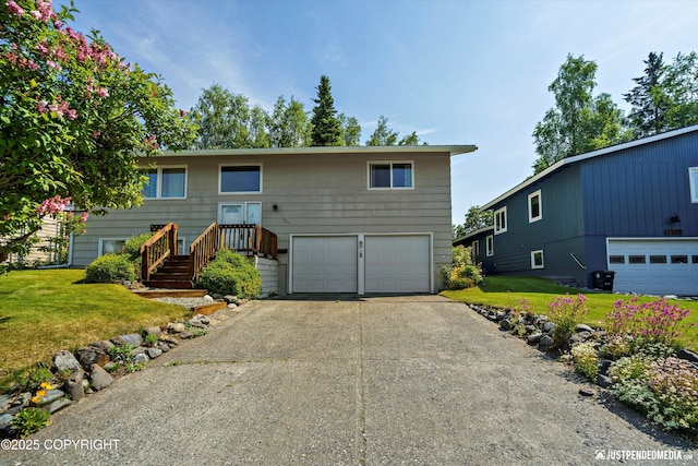 3217 Purdue St, Anchorage, AK 99508 - raised ranch featuring a garage, driveway, and a front lawn