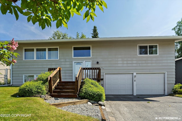 3217 Purdue St, Anchorage, AK 99508 - view of front of house with a garage, driveway, and a front lawn