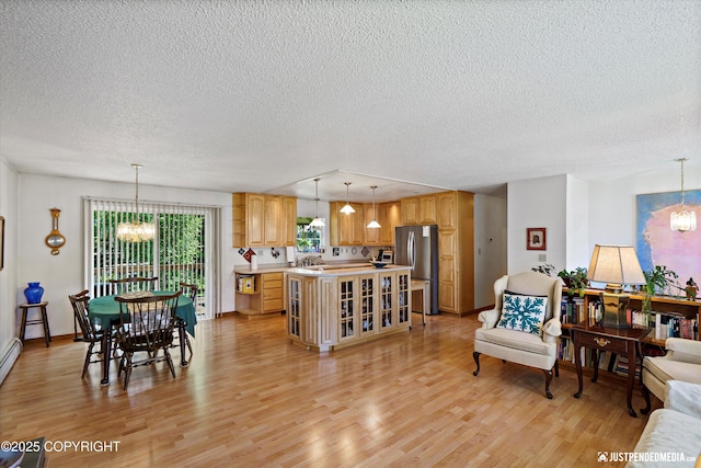 3217 Purdue St, Anchorage, AK 99508 - living area featuring a chandelier, a textured ceiling, and light wood finished floors