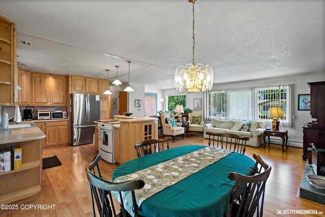 3217 Purdue St, Anchorage, AK 99508 - dining room with a textured ceiling, a chandelier, light wood-type flooring, and baseboard heating