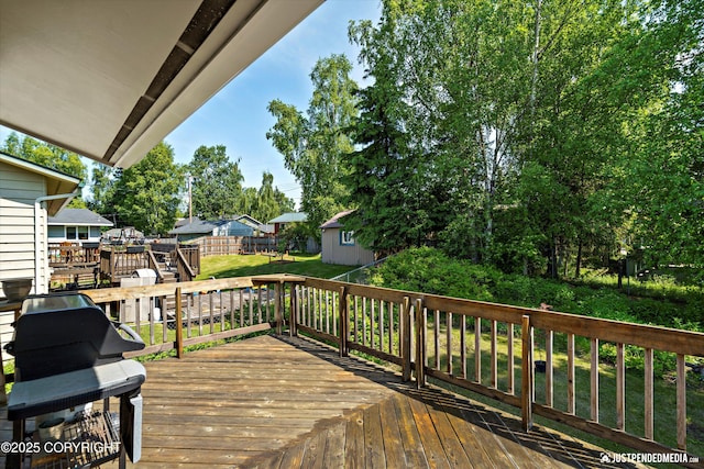 3217 Purdue St, Anchorage, AK 99508 - wooden deck featuring grilling area, a lawn, and a storage unit