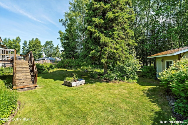 3217 Purdue St, Anchorage, AK 99508 - view of green lawn with stairway and a deck