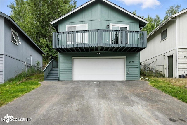 1928 Commodore Dr, Anchorage, AK 99507 - view of front facade with a garage, a balcony, and driveway