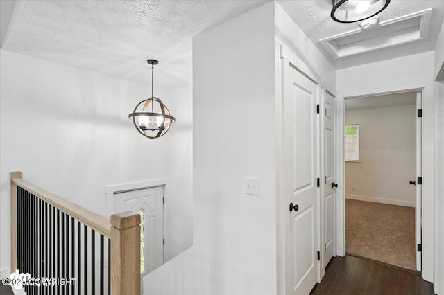 1928 Commodore Dr, Anchorage, AK 99507 - hallway with dark wood finished floors, a textured ceiling, and an upstairs landing