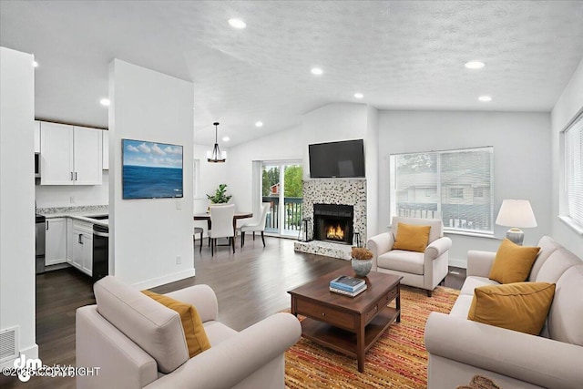 1928 Commodore Dr, Anchorage, AK 99507 - living room featuring dark wood-style floors, vaulted ceiling, recessed lighting, a tile fireplace, and a chandelier