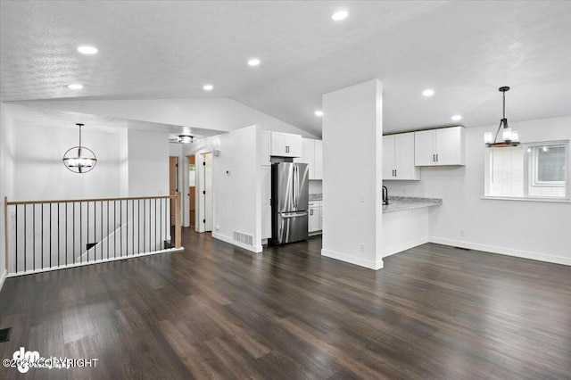 1928 Commodore Dr, Anchorage, AK 99507 - unfurnished living room featuring a chandelier, lofted ceiling, dark wood finished floors, and recessed lighting