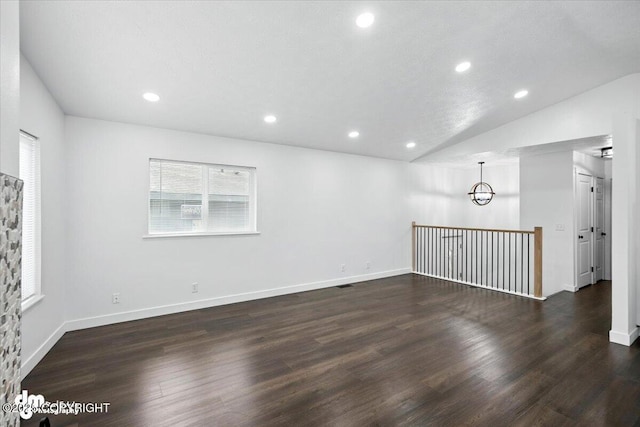 1928 Commodore Dr, Anchorage, AK 99507 - empty room with dark wood-type flooring, recessed lighting, vaulted ceiling, and a chandelier