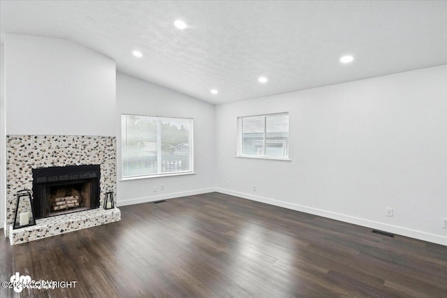 1928 Commodore Dr, Anchorage, AK 99507 - unfurnished living room with vaulted ceiling, wood finished floors, recessed lighting, and a fireplace with raised hearth