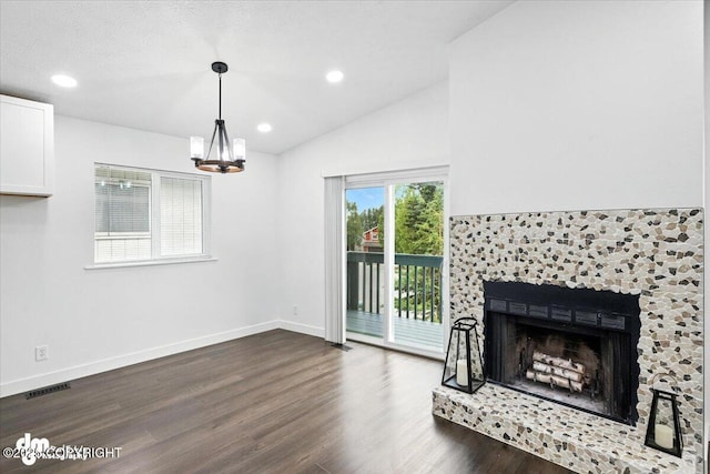 1928 Commodore Dr, Anchorage, AK 99507 - unfurnished living room with dark wood-style flooring, vaulted ceiling, a chandelier, recessed lighting, and a fireplace with raised hearth