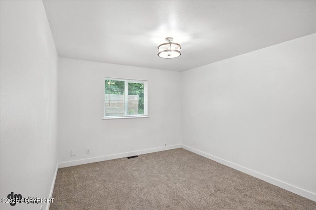 1928 Commodore Dr, Anchorage, AK 99507 - carpeted empty room featuring baseboards