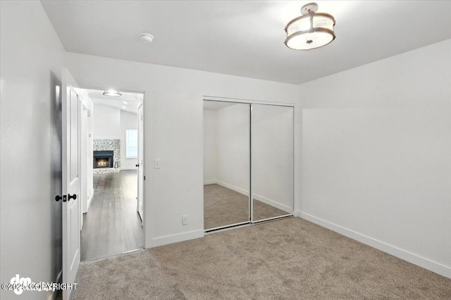 1928 Commodore Dr, Anchorage, AK 99507 - unfurnished bedroom featuring carpet floors, a closet, and a tiled fireplace