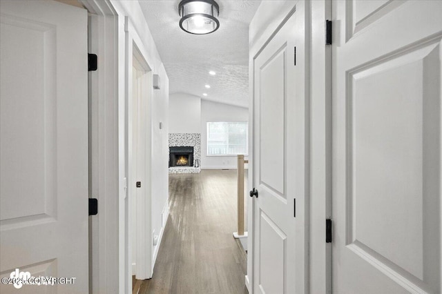 1928 Commodore Dr, Anchorage, AK 99507 - hall with a textured ceiling, lofted ceiling, wood finished floors, and recessed lighting