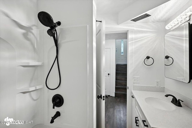 1928 Commodore Dr, Anchorage, AK 99507 - bathroom with vanity, wood finished floors, and shower / washtub combination