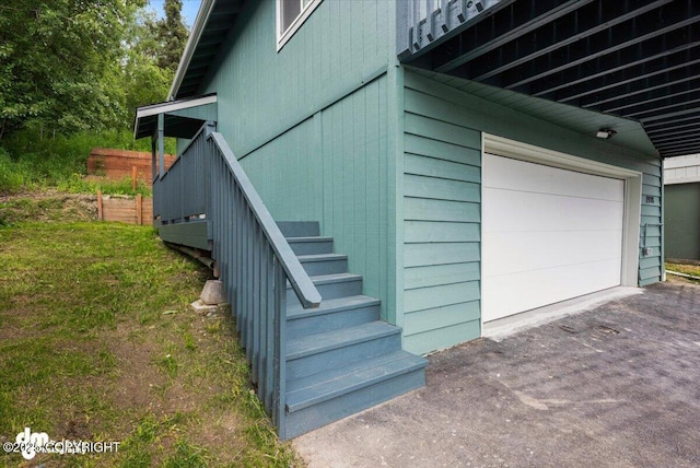 1928 Commodore Dr, Anchorage, AK 99507 - view of side of property featuring a garage, asphalt driveway, and stairs