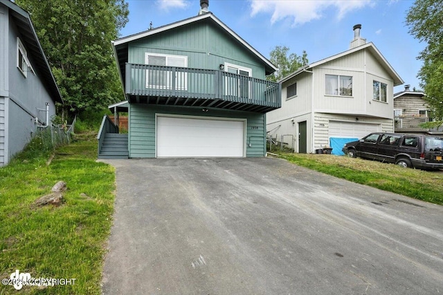 1928 Commodore Dr, Anchorage, AK 99507 - view of front of home with an attached garage and a balcony