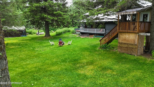 2600 Birch St, Seward, AK 99664 - view of green lawn featuring an outdoor fire pit, stairway, and a wooden deck