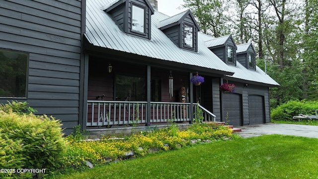 2600 Birch St, Seward, AK 99664 - view of front of property with a porch, a metal roof, a front yard, and driveway