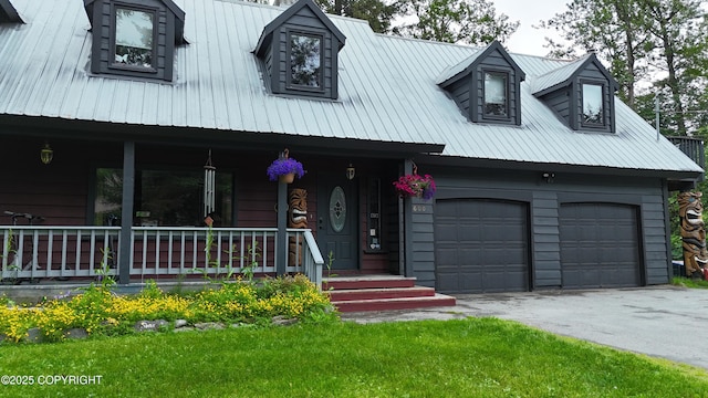 2600 Birch St, Seward, AK 99664 - view of front of house featuring a metal roof, a porch, asphalt driveway, and an attached garage